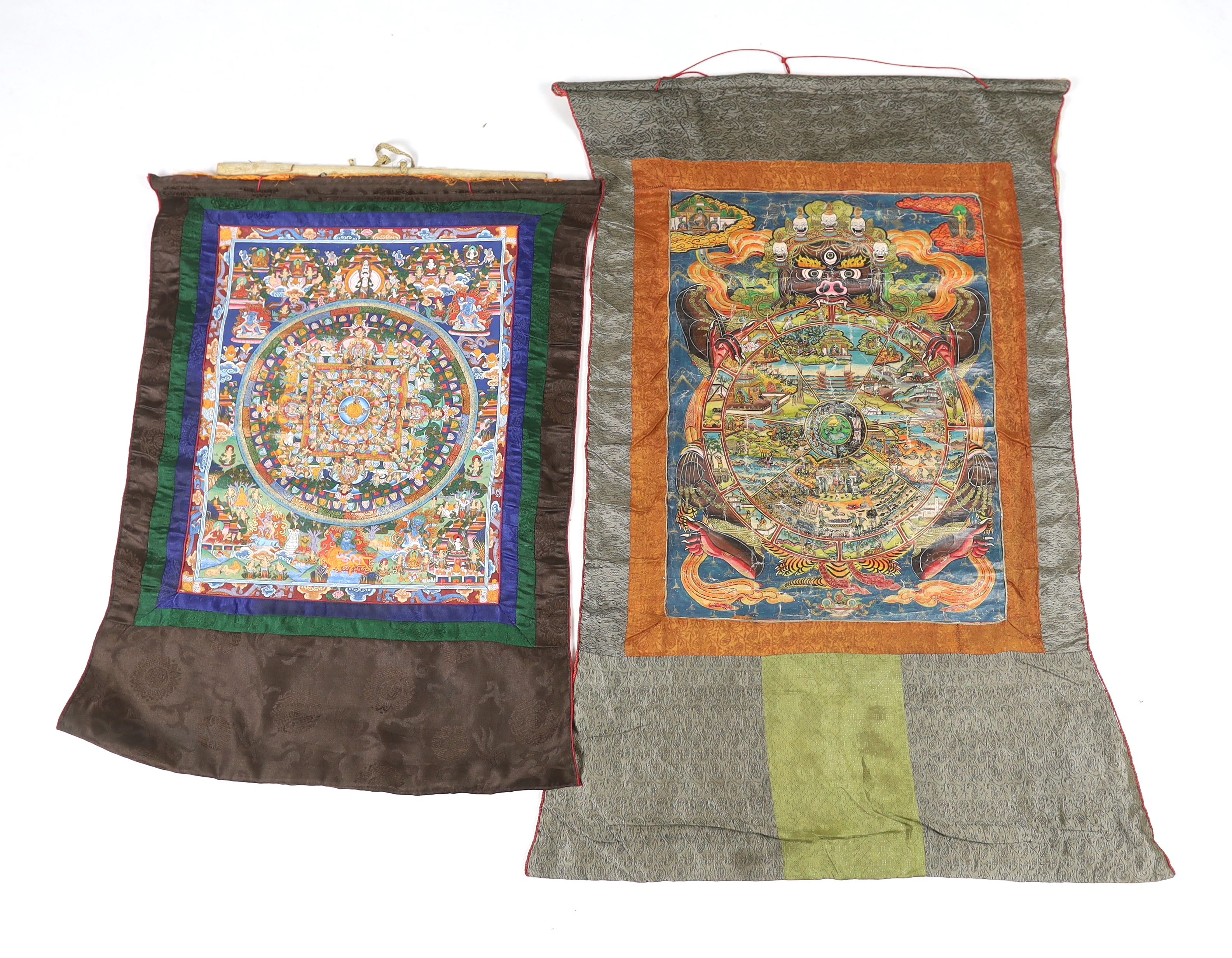 Two Tibetan 20th century Nepalese Thangka and a Burmese Sutra, one Thangka depicting six sections of life, the other a Mandala of Heaven and Earth, 38cm wide, 47cm high (not including silk borders), together with a simpl